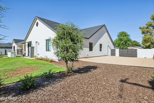 view of home's exterior featuring a patio and a yard