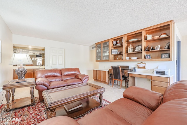 living room featuring built in desk and a textured ceiling