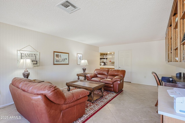 living room featuring light tile patterned floors and a textured ceiling