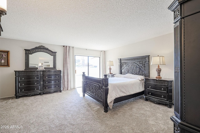 bedroom with access to exterior, carpet, and a textured ceiling