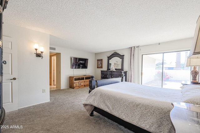 carpeted bedroom featuring access to outside and a textured ceiling