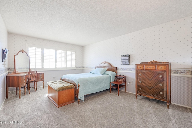 bedroom with light carpet and a textured ceiling