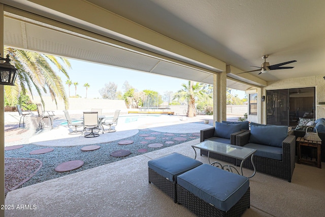 view of patio / terrace with a fenced in pool, an outdoor hangout area, and ceiling fan