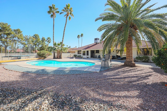 view of pool featuring a patio area and central air condition unit