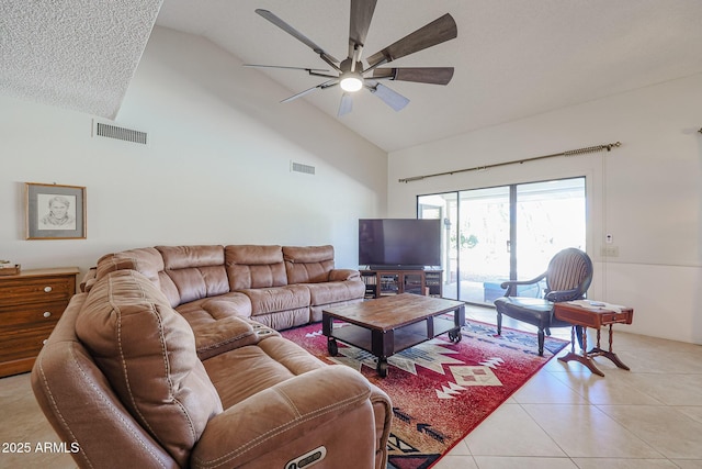 living room featuring high vaulted ceiling, light tile patterned floors, and ceiling fan