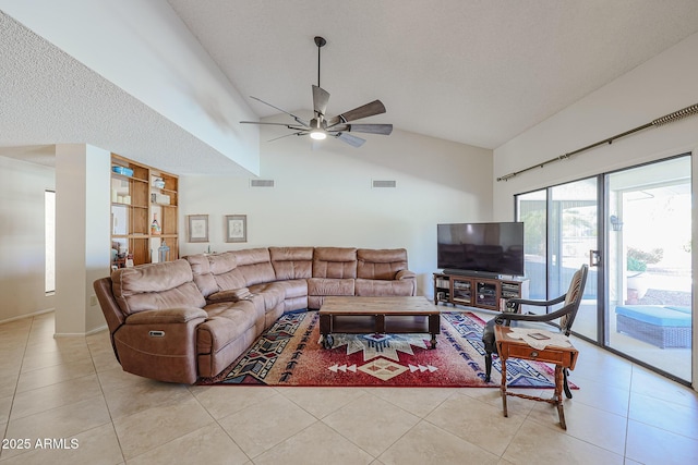 living room with light tile patterned floors, high vaulted ceiling, a textured ceiling, and ceiling fan