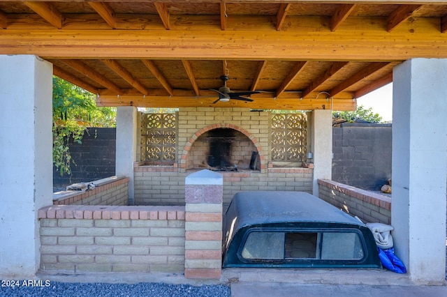 view of patio / terrace with ceiling fan and exterior fireplace