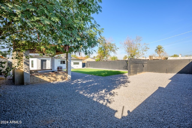 view of yard featuring a patio and an outdoor kitchen