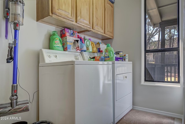 laundry room featuring cabinets, independent washer and dryer, and light carpet