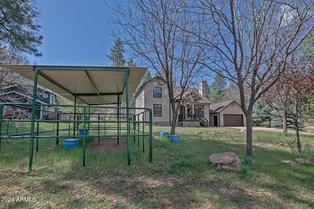 view of yard with a garage and an outdoor structure