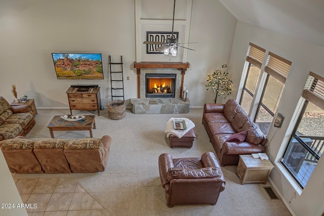 living room featuring light carpet, a fireplace, and high vaulted ceiling