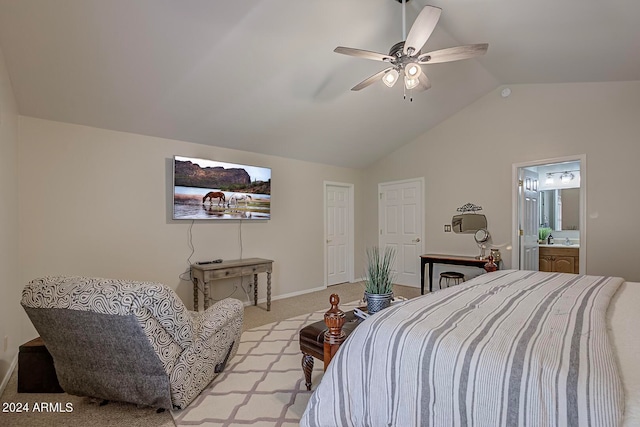 bedroom featuring sink, ensuite bath, vaulted ceiling, ceiling fan, and light colored carpet