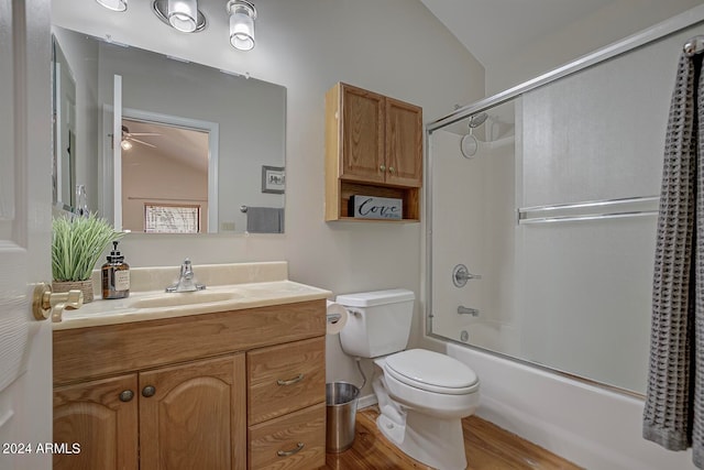 full bathroom with enclosed tub / shower combo, wood-type flooring, vaulted ceiling, and toilet