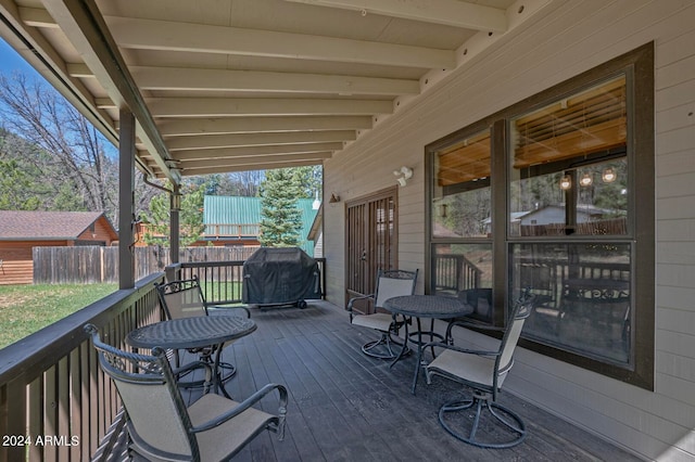 wooden deck with a grill