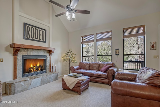 living room with carpet, ceiling fan, a fireplace, and high vaulted ceiling