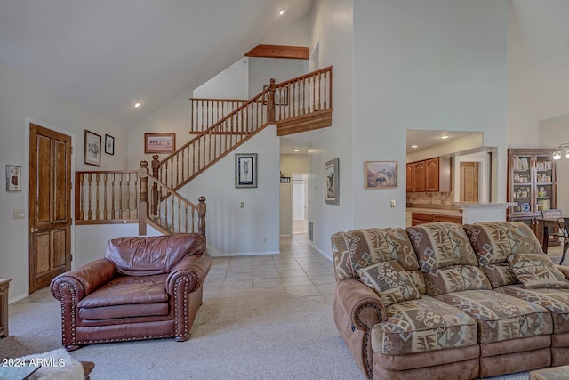 living room with light colored carpet and high vaulted ceiling