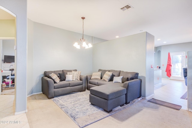 carpeted living room with a notable chandelier