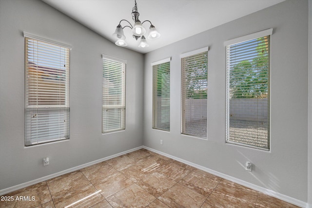 3592 E Sandwick Dr, San Tan Valley, AZ 85140 - unfurnished room with baseboards and a notable chandelier