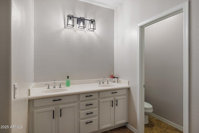 3592 E Sandwick Dr, San Tan Valley, AZ 85140 - full bath featuring toilet, double vanity, a sink, and baseboards