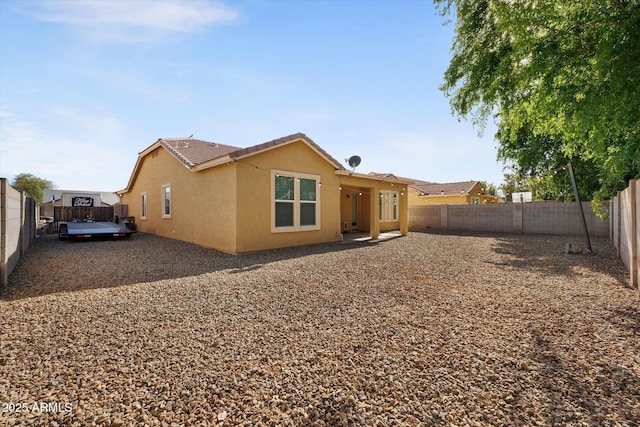 3592 E Sandwick Dr, San Tan Valley, AZ 85140 - rear view of house with a fenced backyard, a tile roof, and stucco siding