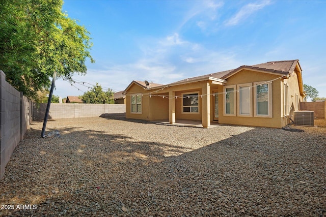 3592 E Sandwick Dr, San Tan Valley, AZ 85140 - back of property featuring a fenced backyard, stucco siding, a patio area, a tile roof, and central AC unit