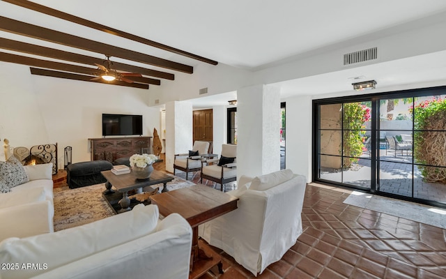 tiled living room with ceiling fan and beam ceiling