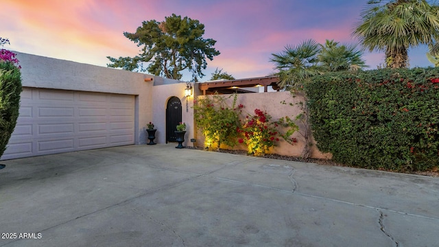 pueblo-style house with a garage