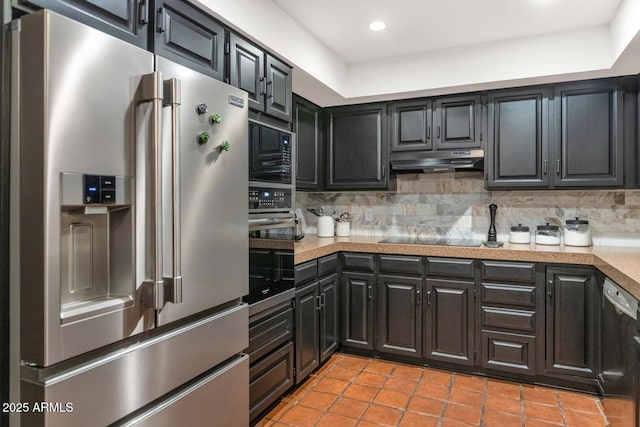 kitchen featuring light tile patterned floors, tasteful backsplash, and black appliances