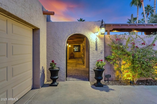 exterior entry at dusk with a garage