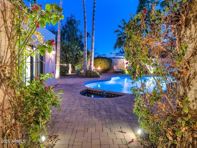 view of pool with an in ground hot tub and a patio