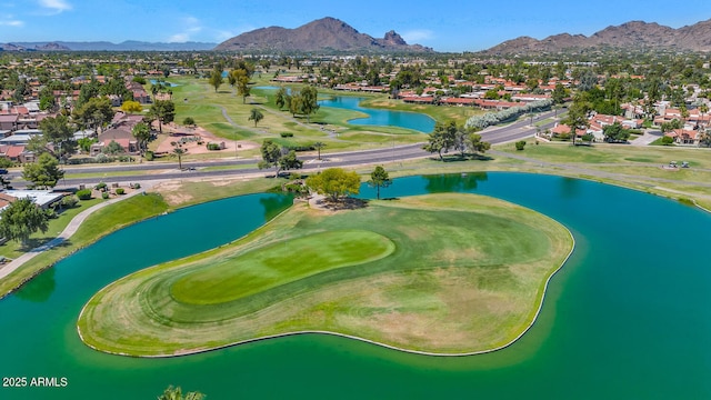 birds eye view of property with a water and mountain view