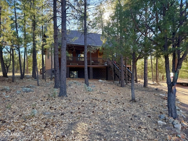 back of property featuring a wooden deck