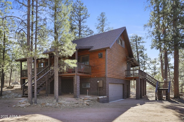 cabin featuring a balcony and a garage