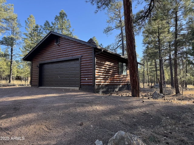 exterior space with an outbuilding and a garage