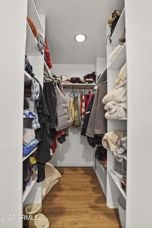 spacious closet featuring hardwood / wood-style floors