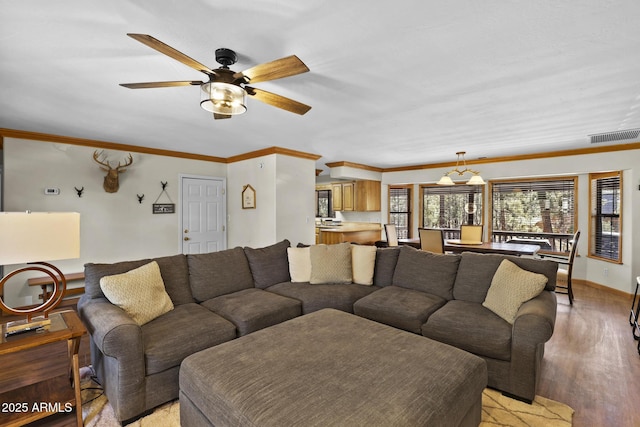 living room with crown molding, ceiling fan, and light wood-type flooring