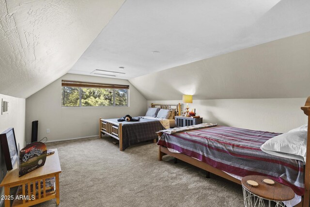 carpeted bedroom featuring vaulted ceiling and a textured ceiling