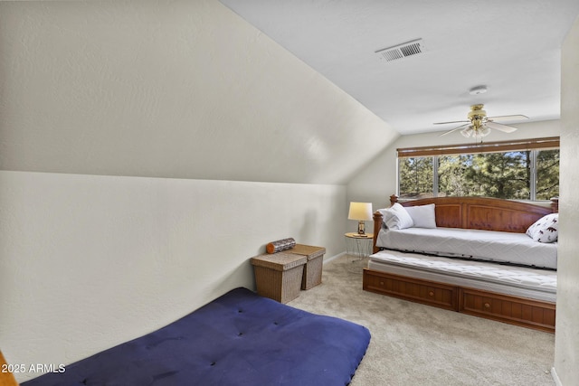 carpeted bedroom with vaulted ceiling and ceiling fan