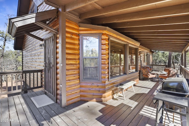 wooden terrace with a grill