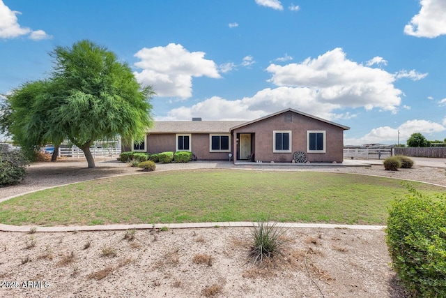 single story home with a front lawn