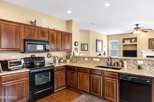 kitchen with dark wood-style floors, light stone countertops, ceiling fan, a sink, and black appliances