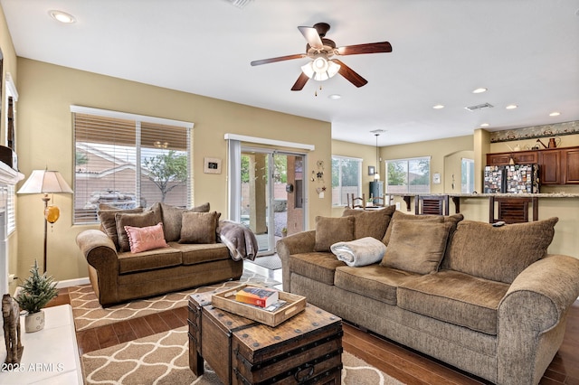 living area featuring dark wood-type flooring, recessed lighting, a ceiling fan, and visible vents