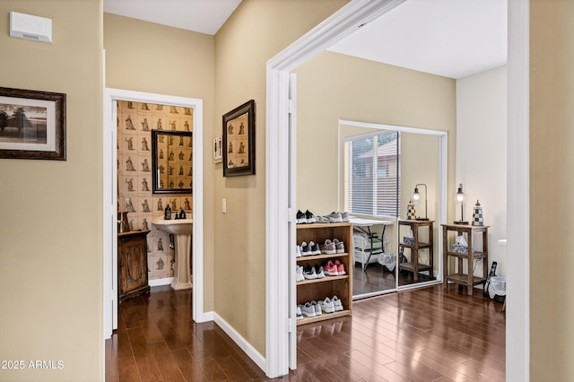 hall featuring baseboards and dark wood-style floors