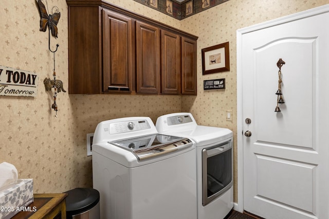 clothes washing area featuring cabinet space, wallpapered walls, and separate washer and dryer