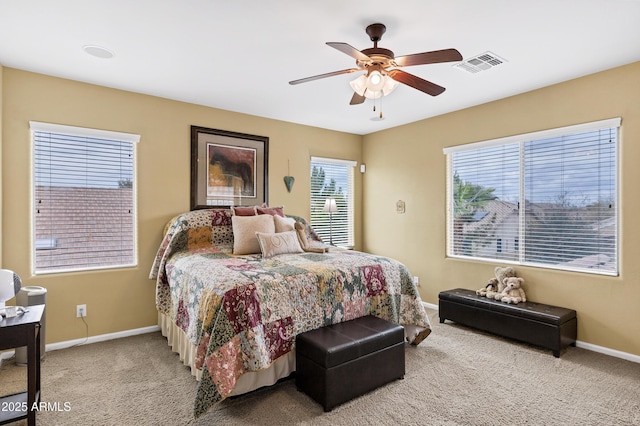 carpeted bedroom featuring visible vents, baseboards, and ceiling fan