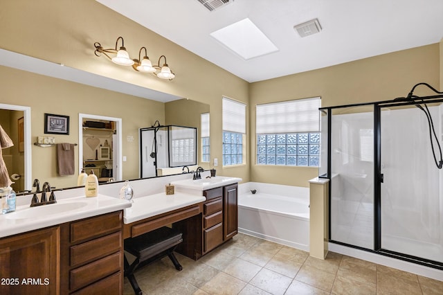 full bath with double vanity, a stall shower, a sink, tile patterned floors, and a bath