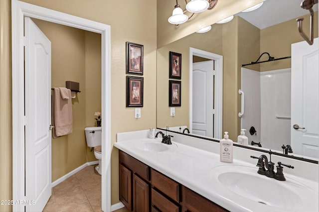 full bath featuring tile patterned flooring, double vanity, toilet, and a sink