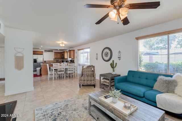 living room featuring ceiling fan and light tile patterned floors