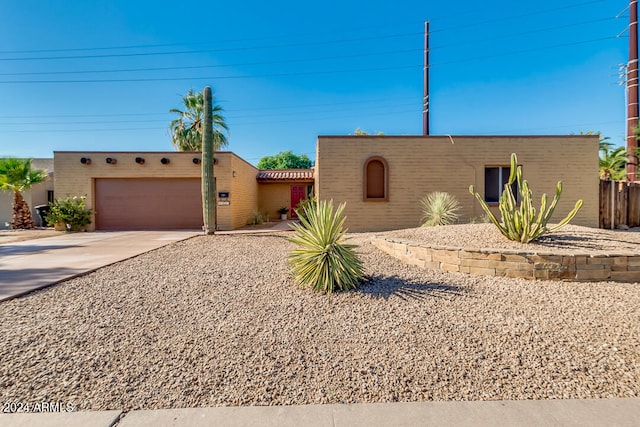 pueblo revival-style home with a garage