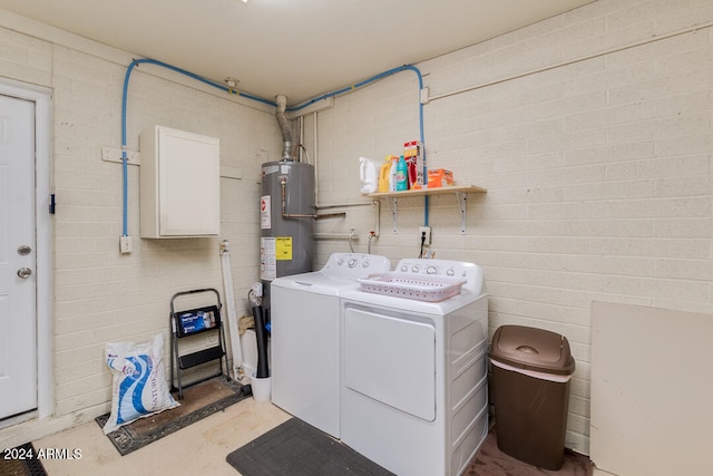 washroom with water heater and washer and clothes dryer